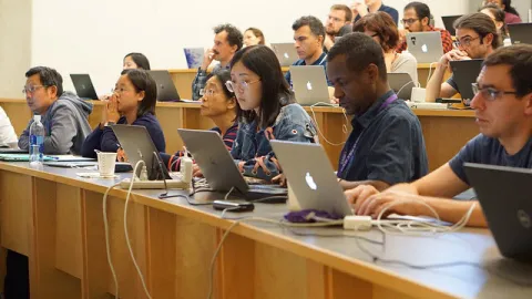 Students with laptops at desks